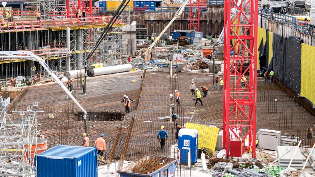 pexels-photo-18283441 Workers Laying Out Concrete Reinforcements at the Construction Site
